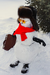 Still life of Merry Christmas and a Happy New Year. A happy snowman in a fur sable hat, red...