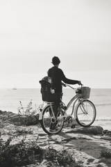 Father and child biking on beach coastline outside nature background. Blurred outdoors image of active family bike ride. Healthy activity lifestyle, having fun travel vacation