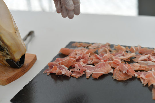 Dry cured ham thinly sliced. Closeup on slices of prosciutto Italian delicatessen. Festive time background