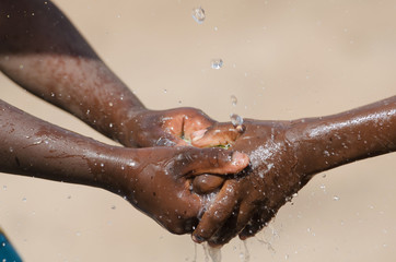 Fototapeta premium Water Issues in Africa - Black Children Washing Hands