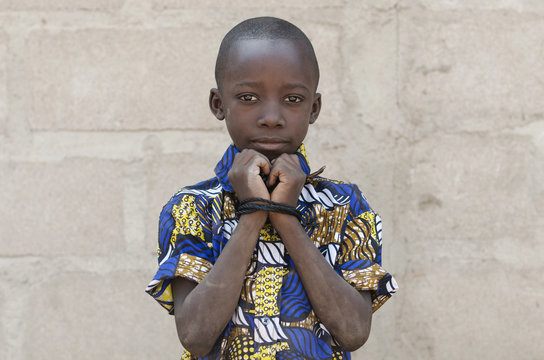 Headshot of African Black Boy Standing Outdoors Hands Rope