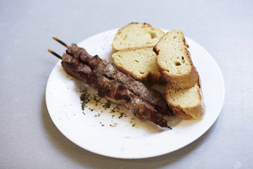 Greek souvlaki on a plate with bread