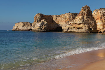 View of sand beaches with rocks washed by atlantic ocean on sunny summer days, Portugal , Algarve