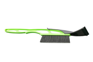 Brush for snow cleaning. Green brush on white background. Winter. Snow