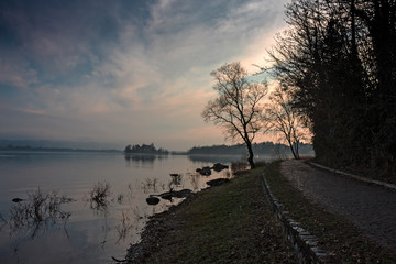 Cycle and pedestrian path of the Varese lake at sunset.