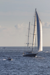 Fototapeta na wymiar Sailboat sailing in the evening
