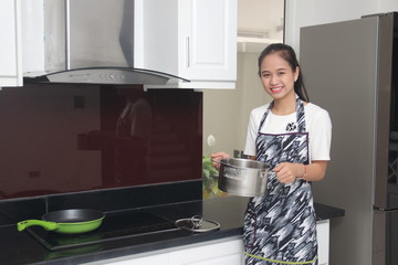 The woman cooking in a kitchen