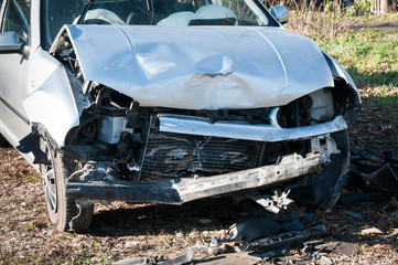 Car crash damage. Front side of broken and damaged car wreck in crash accident with fatal outcome in collision