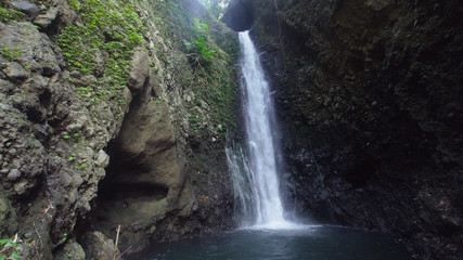 Fototapeta na wymiar Waterfall in green rainforest. waterfall in the mountain jungle. Bali,Indonesia. Travel concept.