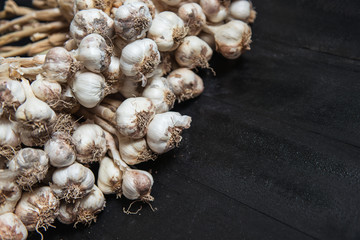 Fototapeta na wymiar Garlic over a dark background