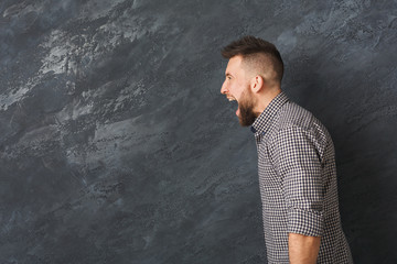 Man expressing anger, feeling furious, shouting