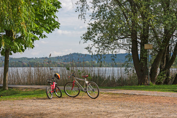 Two bicycles standing by the lake