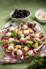 mixed salad with pineapple  mozzarella arugula and chicory, selective focus