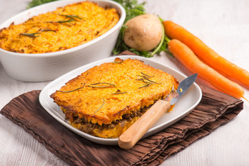 cake with potatoes carrots and minced meat, selective focus