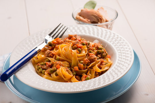 tagliatelle with tuna ragout and green peas, selective focus