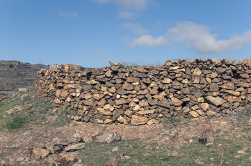 Old stones wall weathered by time in inner Spain`s countryside