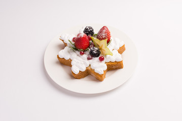 Homemade cake with whipped cream, strawberries and blackberries on white background