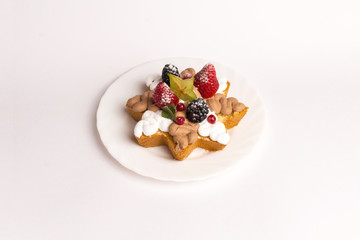 Homemade cake with whipped cream, strawberries and blackberries on white background