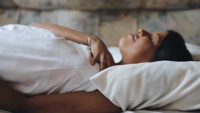 Woman wake up in morning lying on bed