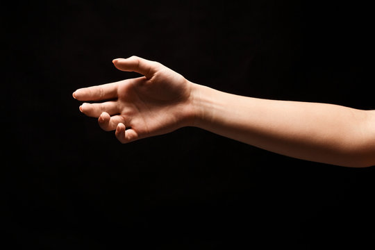 Hand ready for handshake isolated on black