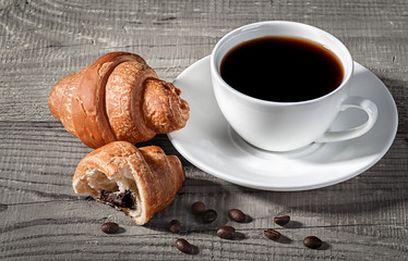Coffee and croissants on a wooden table