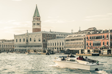 Fototapeta premium Piazza San Marco background, viewpoint from canal, Symbol of Venice, Campanile Bell tower in Italy, Bell tower in Venice with taxi boat