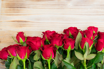 Fototapeta na wymiar Red blooming roses on wood