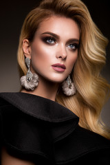 Beautyful girl with bright make up and beautiful hairstyle in black dress