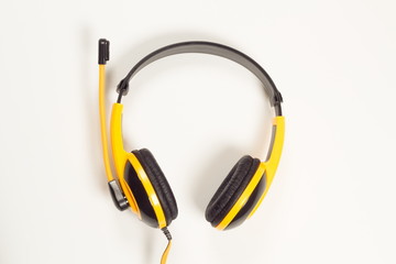 Ear headphones yellow on a white background