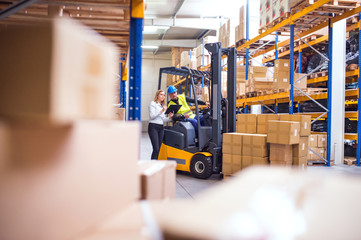 Young warehouse workers working together. © Halfpoint