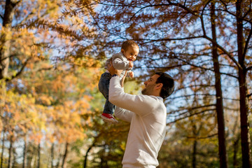 Fototapeta premium Young father and baby boy in autumn park