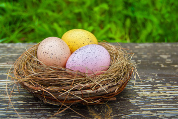 Colored eggs on wooden background. Easter, Spring holidays