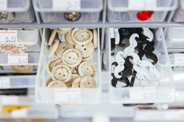 plastic storage container with wooden buttons for decorative purpose