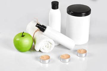 Natural spa beauty treatment cleansing products with apple on white background.