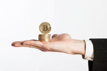 Plakat businessman hand holding bitcoins on a white background
