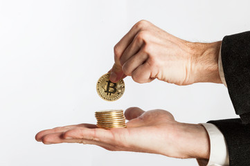 businessman hand holding bitcoins on  a white background