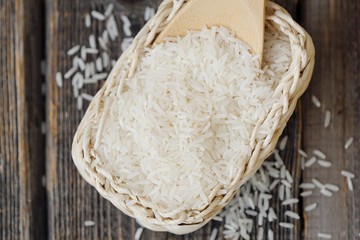 White long grain rice on a wooden spoon