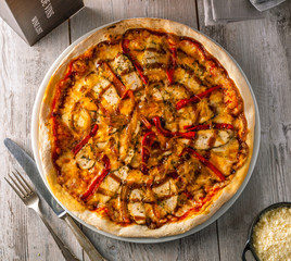 Delicious hot pizza with grilled chicken breast and bell peppers.