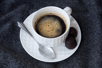 Delicious fresh tasty coffee on grey plaid 
