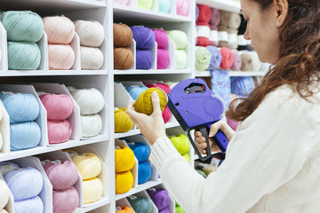 business woman with a label machine updating products on sale