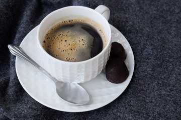 Delicious fresh tasty coffee on grey plaid 