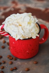 Delicious hot chocolate with whipped cream in red cup 