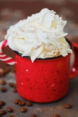 Delicious hot chocolate with whipped cream in red cup 
