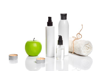Natural spa beauty treatment cleansing products with apple on white background.