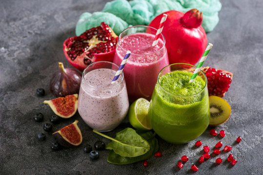Colorful smoothie, healthy detox vitamin diet or vegan food concept, breakfast drink with spinach, pomegranate, figs and blueberries