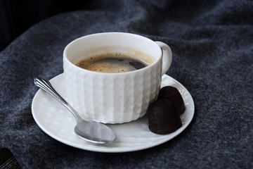 Delicious fresh tasty coffee on grey plaid
