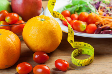 Healthy concept with mixed fruits and vegetables on wooden background