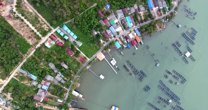 4k aerial movie of fishing farm and fisherman village on the shore of songkhla lake, thailanda