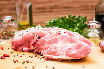 Raw meat on a cutting board with spices.