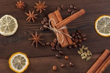 Cinnamon sticks, anise and coffee beans on a wooden background